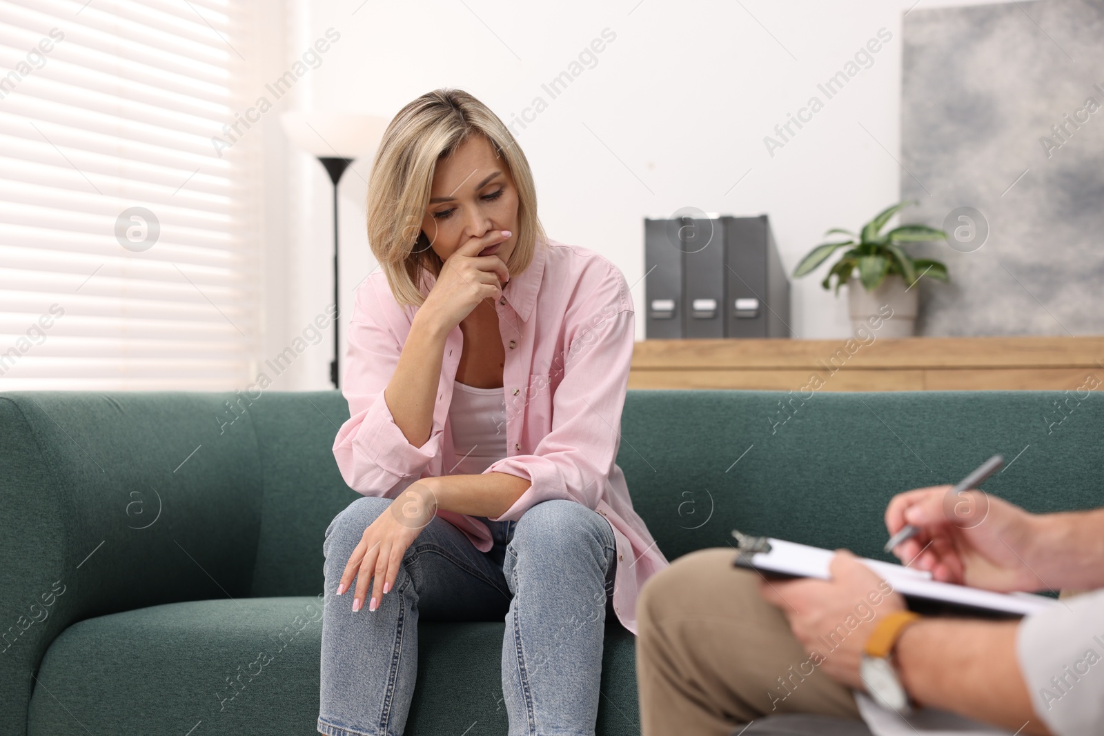 Photo of Professional psychologist working with patient in office, closeup