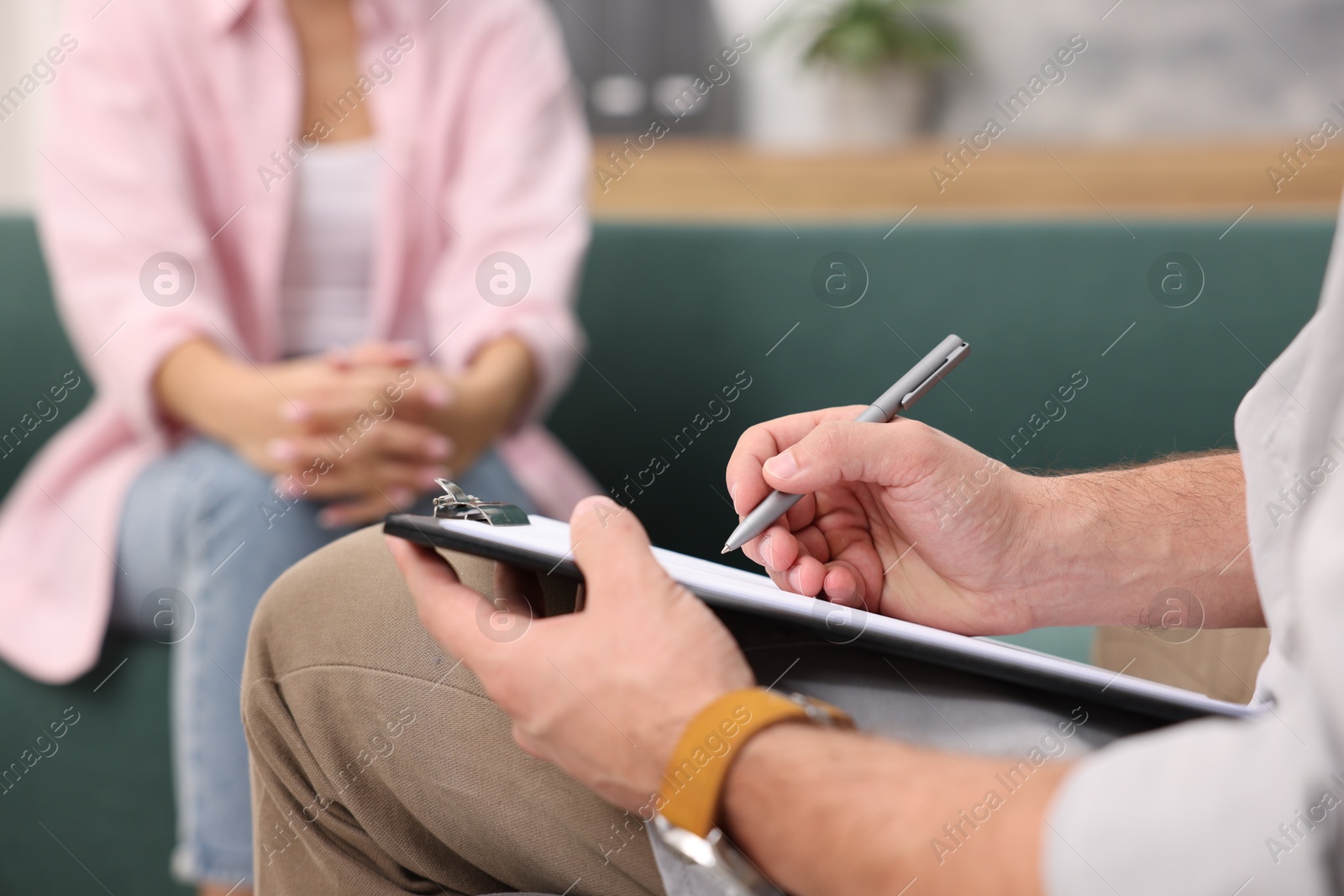 Photo of Professional psychologist working with patient in office, closeup