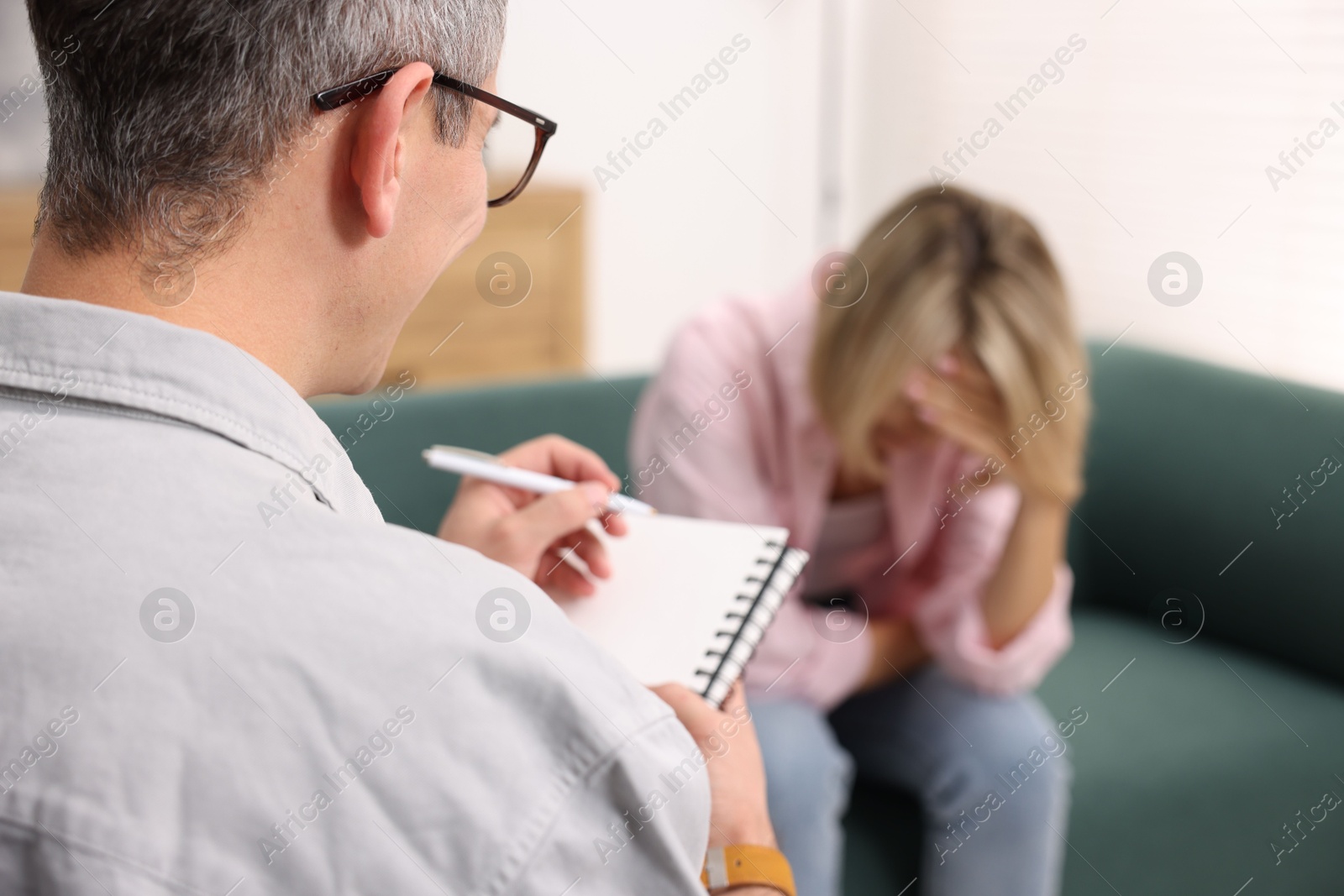 Photo of Professional psychologist working with patient in office, selective focus