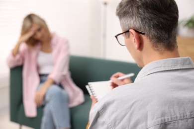 Photo of Professional psychologist working with patient in office, selective focus