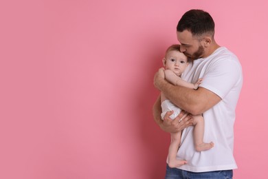 Photo of Father with his cute baby on pink background, space for text