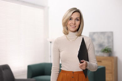 Photo of Portrait of professional psychologist with clipboard in office