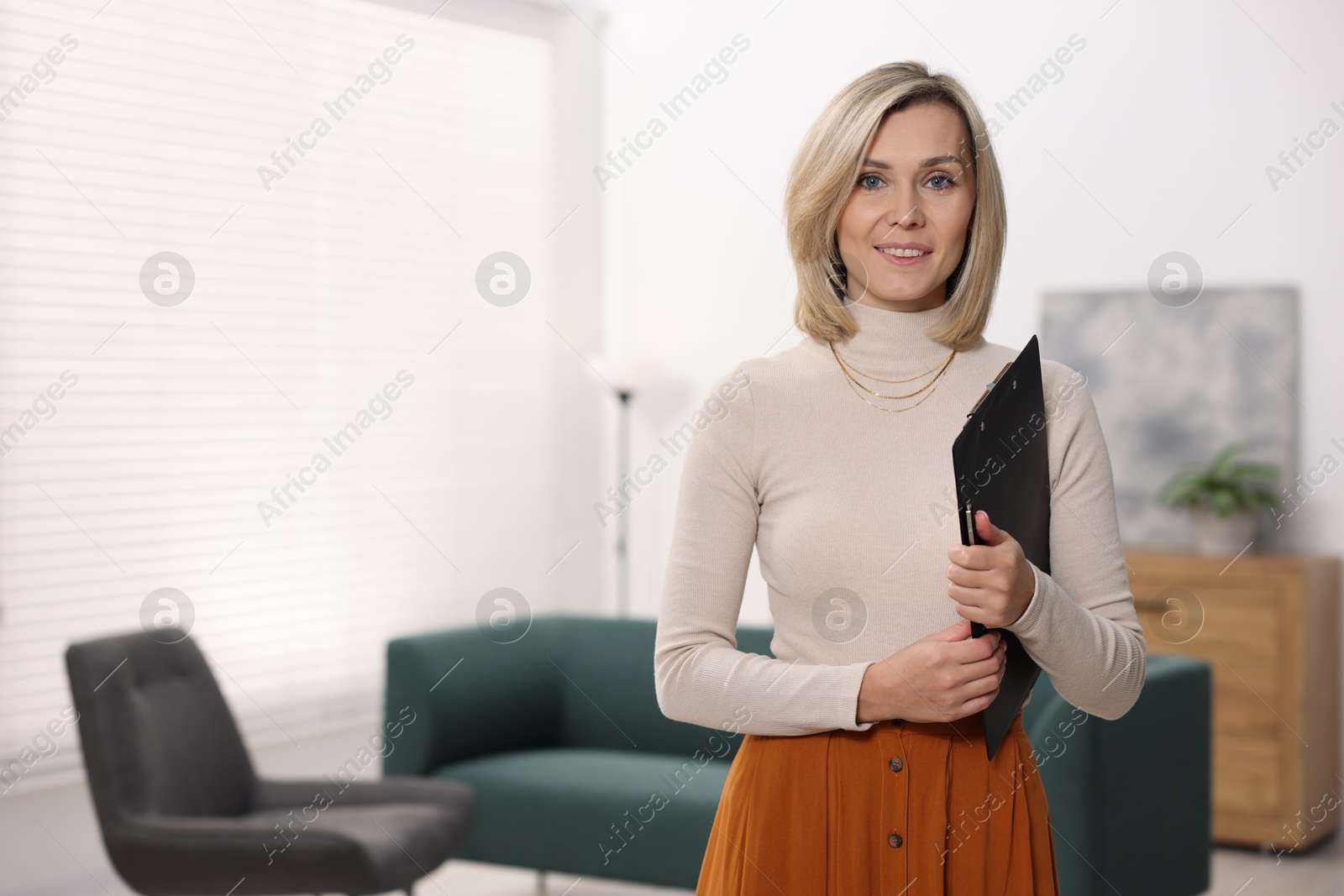 Photo of Portrait of professional psychologist with clipboard in office, space for text