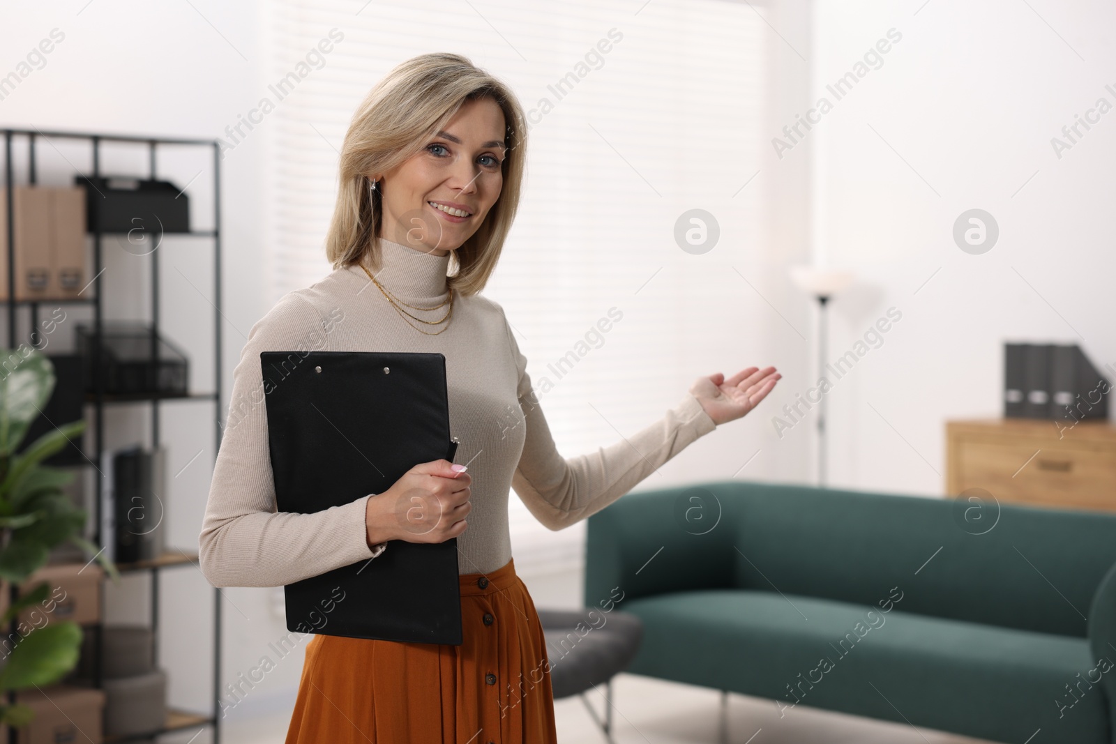 Photo of Portrait of professional psychologist with clipboard in office, space for text