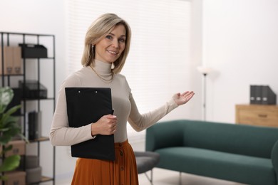 Photo of Portrait of professional psychologist with clipboard in office, space for text