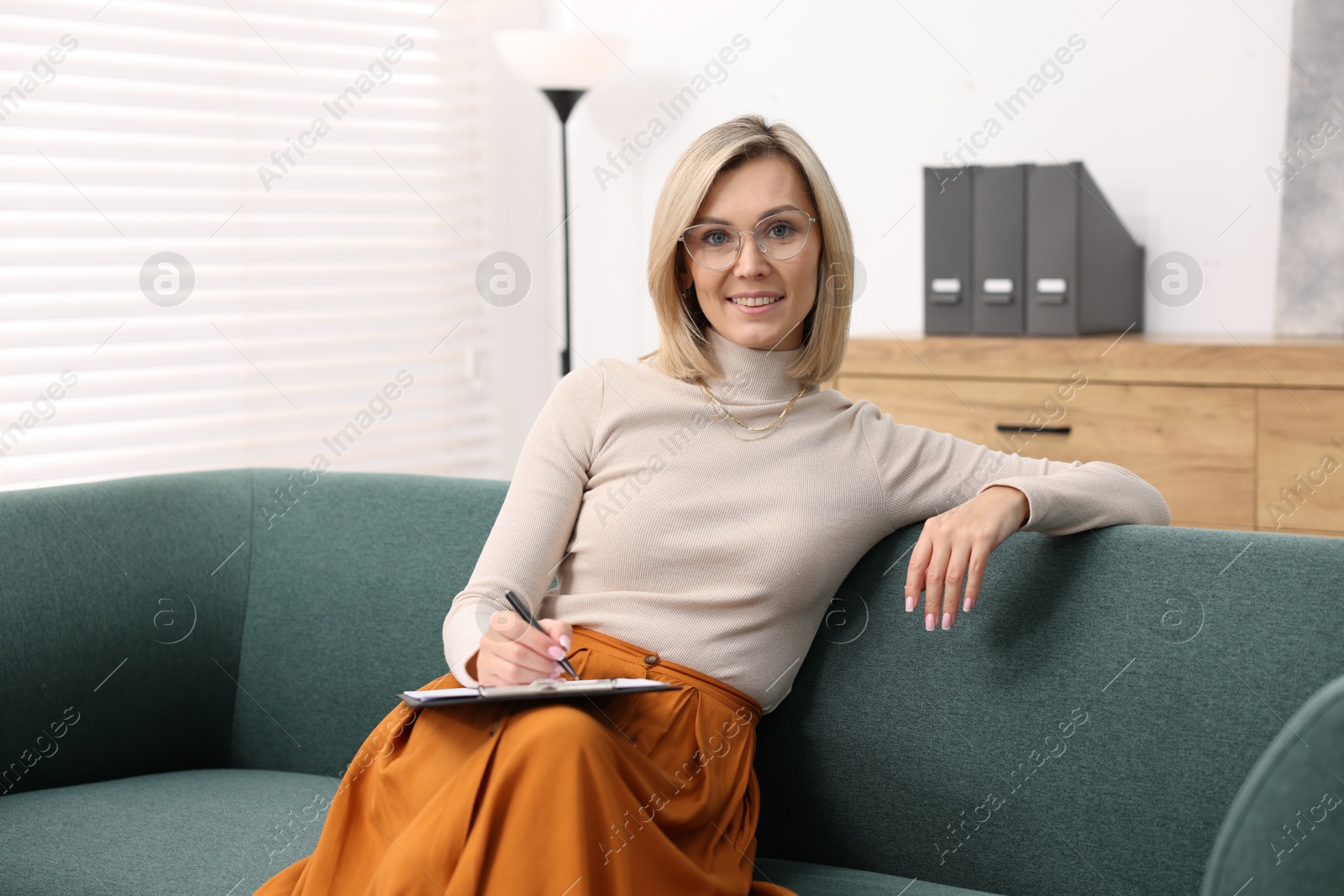 Photo of Portrait of professional psychologist with clipboard in office