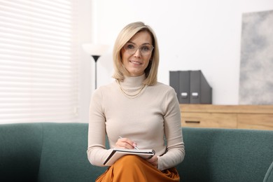 Photo of Portrait of professional psychologist with notebook in office