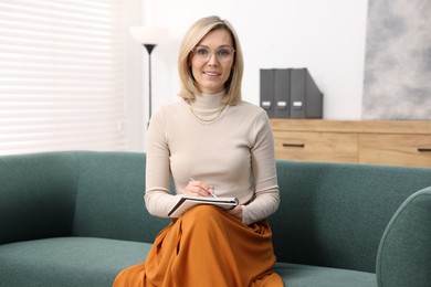 Photo of Portrait of professional psychologist with notebook in office