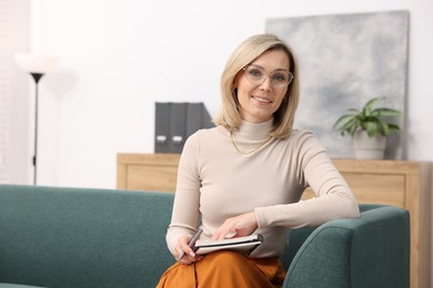 Photo of Portrait of professional psychologist with notebook in office, space for text