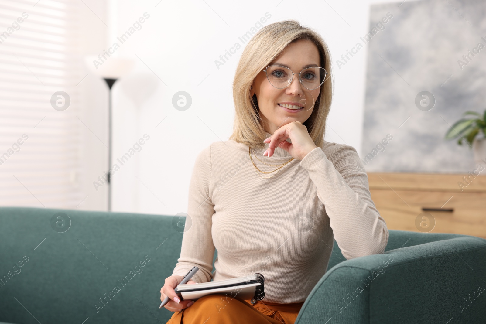 Photo of Portrait of professional psychologist with notebook in office, space for text