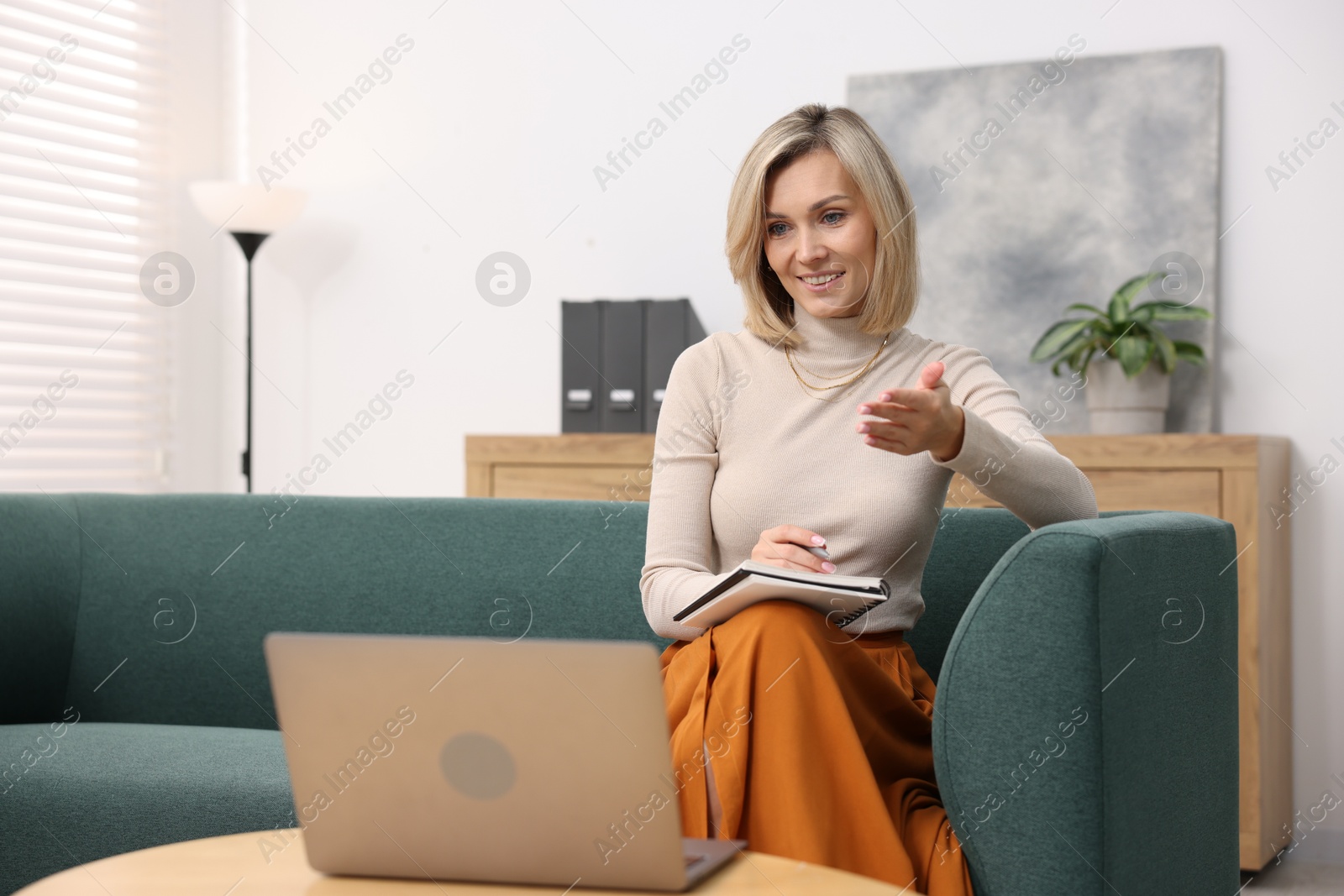 Photo of Professional psychologist working with notebook and laptop in office