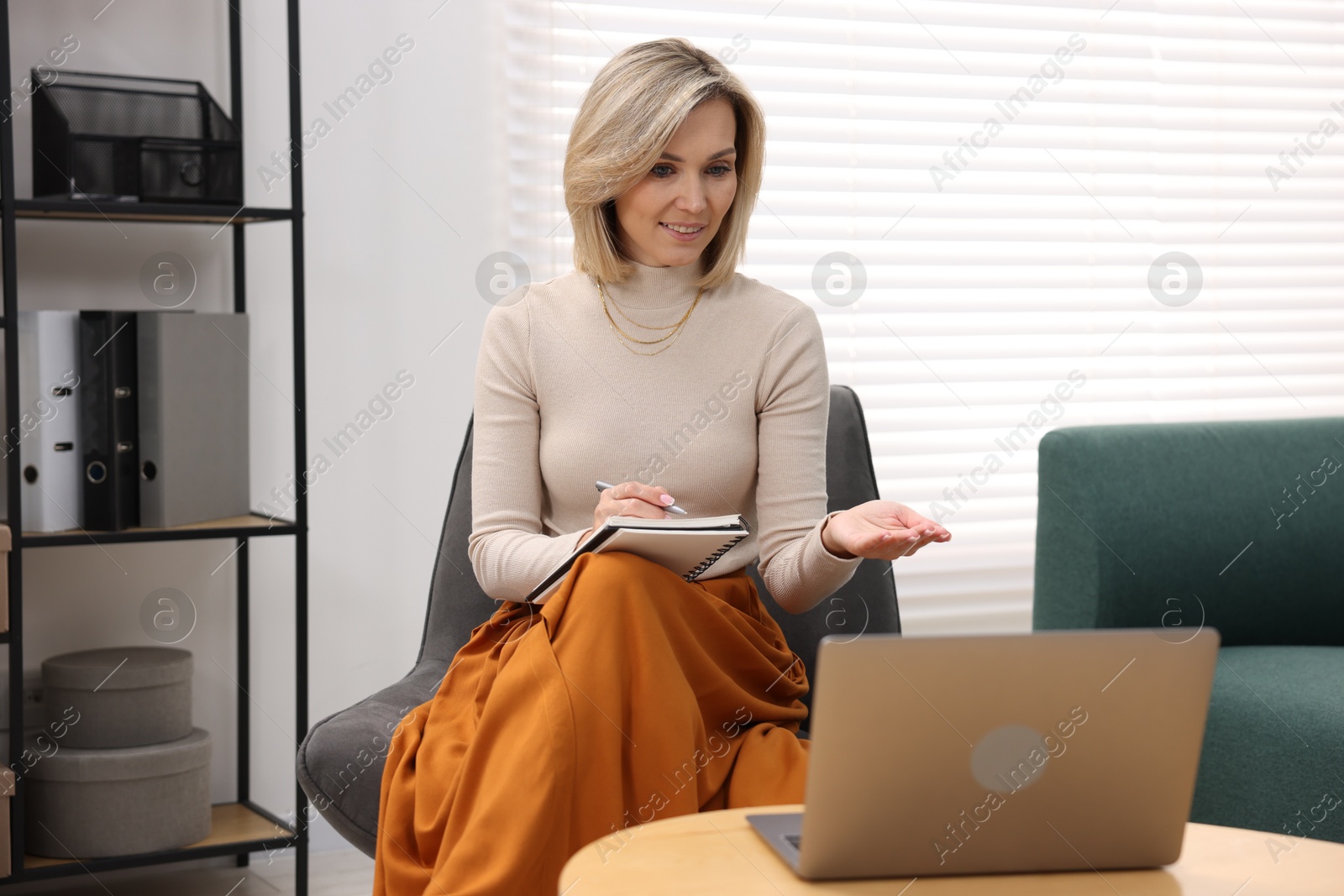 Photo of Professional psychologist working with notebook and laptop in office