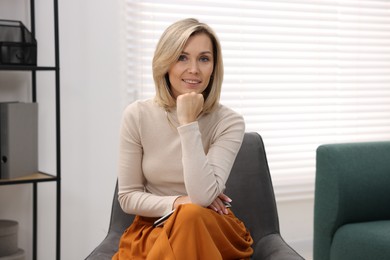 Portrait of professional psychologist with notebook in office