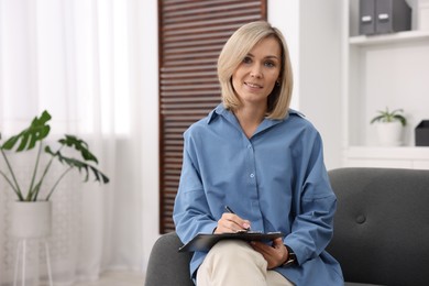 Photo of Portrait of professional psychologist with clipboard in office