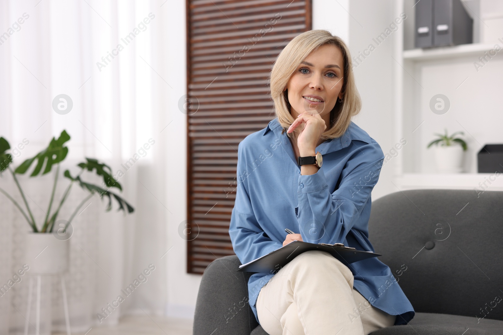 Photo of Portrait of professional psychologist with clipboard in office