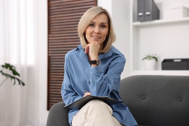 Photo of Portrait of professional psychologist with clipboard in office