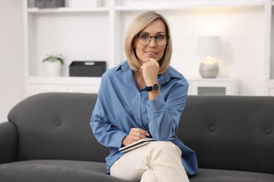 Photo of Portrait of professional psychologist with notebook in office