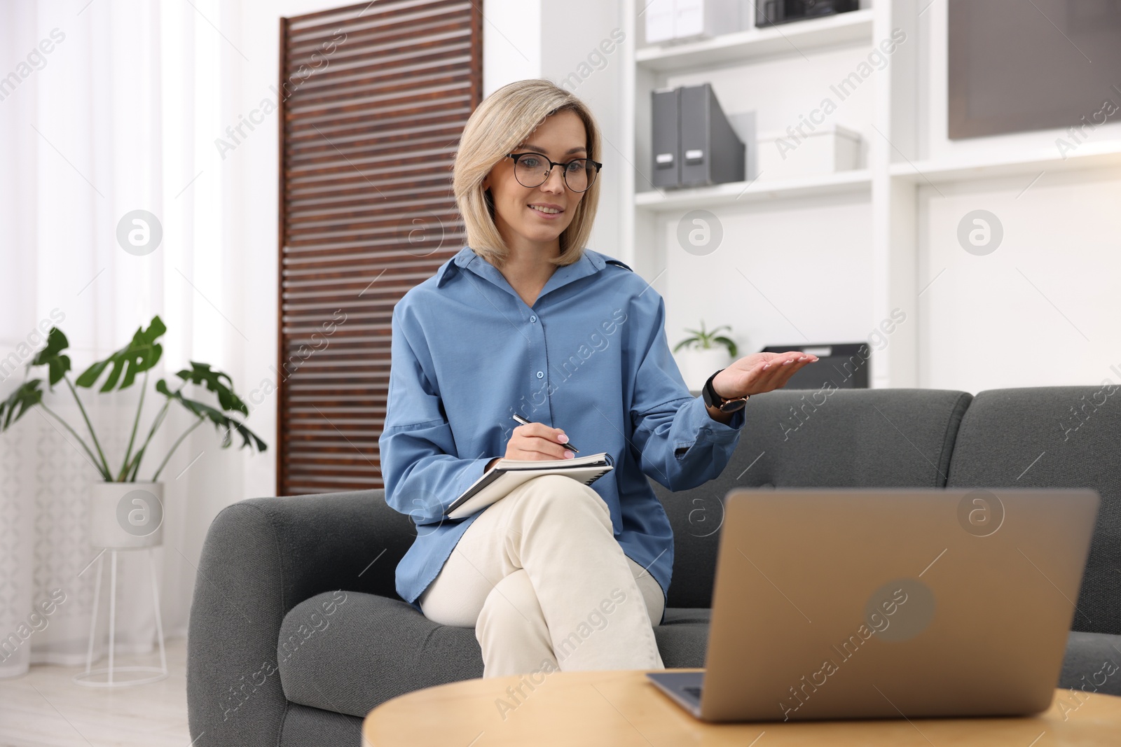 Photo of Professional psychologist working with laptop and notebook in office