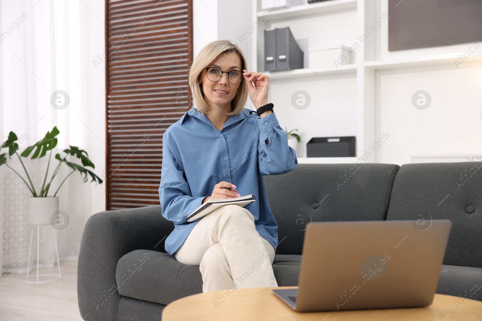 Photo of Professional psychologist working with laptop and notebook in office