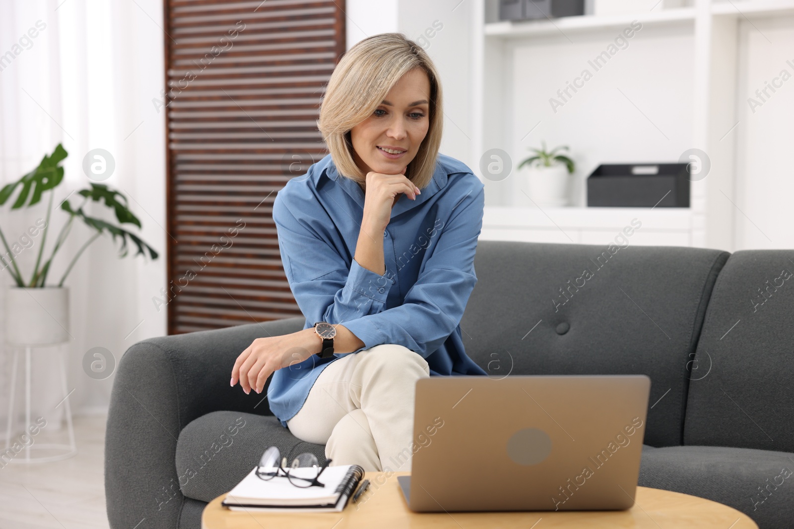 Photo of Professional psychologist working with laptop and notebook in office