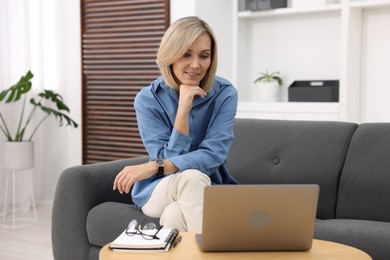 Professional psychologist working with laptop and notebook in office