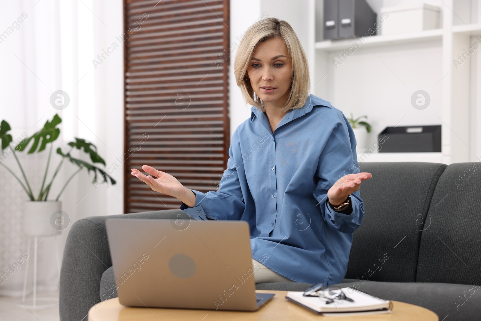 Photo of Professional psychologist working with laptop and notebook in office