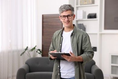 Photo of Portrait of professional psychologist with clipboard in office, space for text