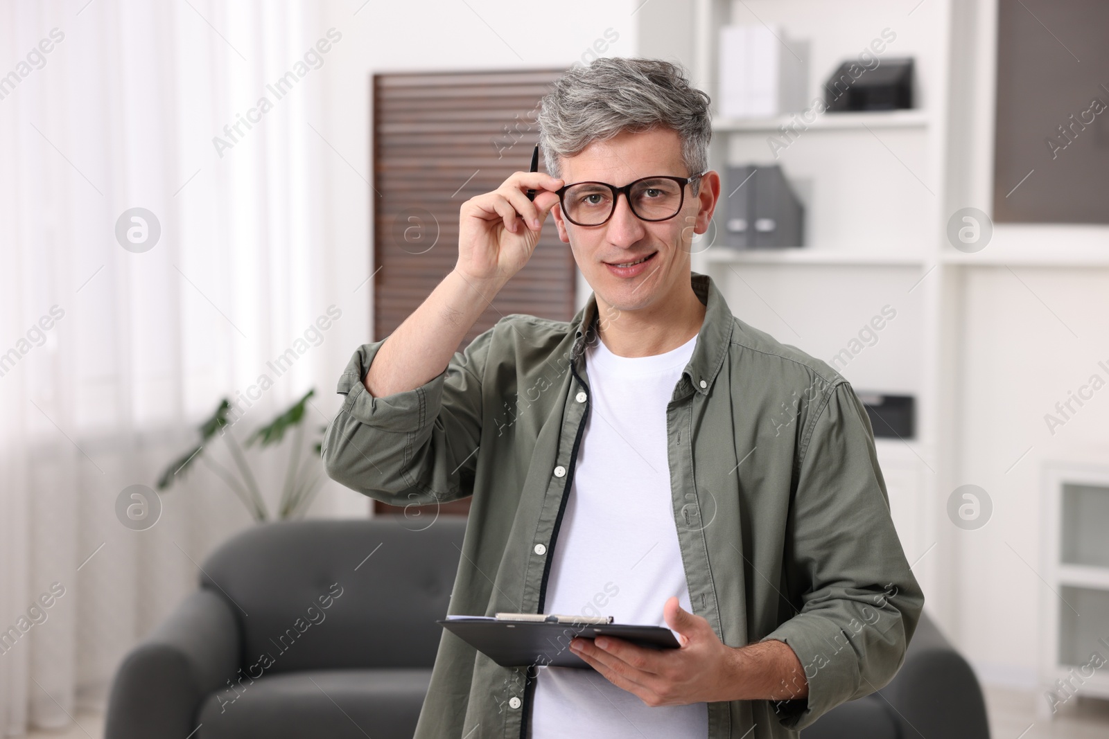 Photo of Portrait of professional psychologist with clipboard in office