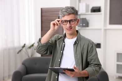 Photo of Portrait of professional psychologist with clipboard in office