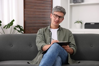 Photo of Portrait of professional psychologist with clipboard in office