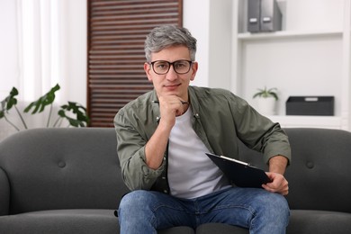 Photo of Portrait of professional psychologist with clipboard in office