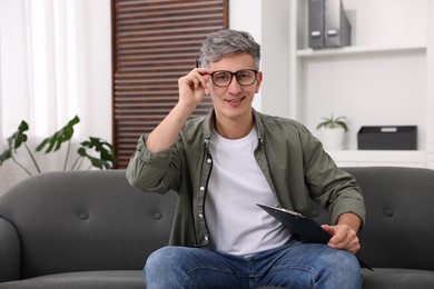 Photo of Portrait of professional psychologist with clipboard in office