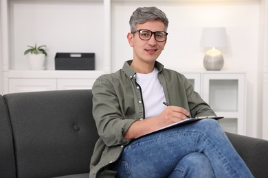 Photo of Portrait of professional psychologist with clipboard in office