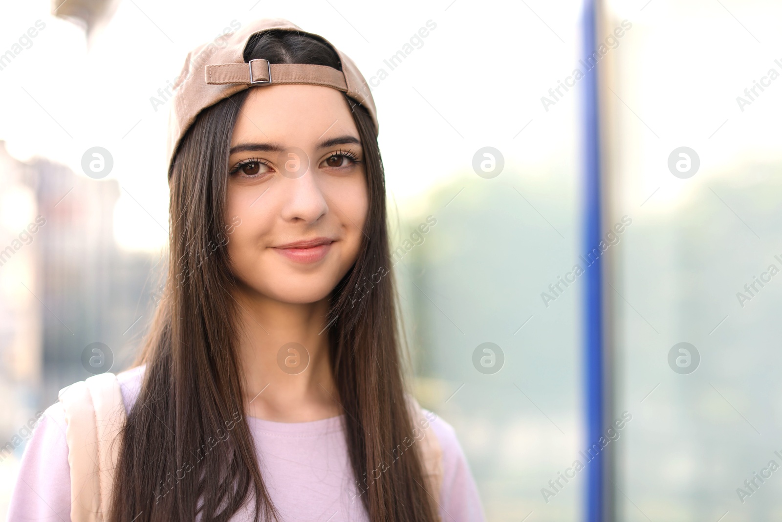 Photo of Portrait of teenage girl in stylish cap outdoors. Space for text