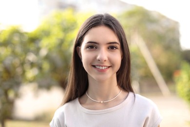 Photo of Portrait of beautiful teenage girl on city street