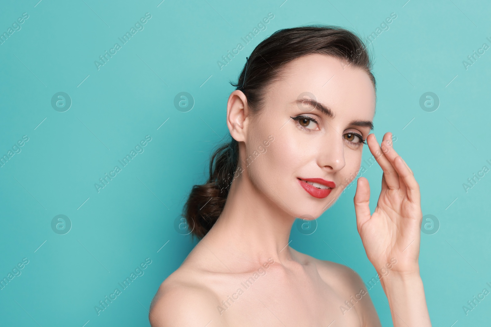 Photo of Woman with perfect makeup on light blue background. Space for text