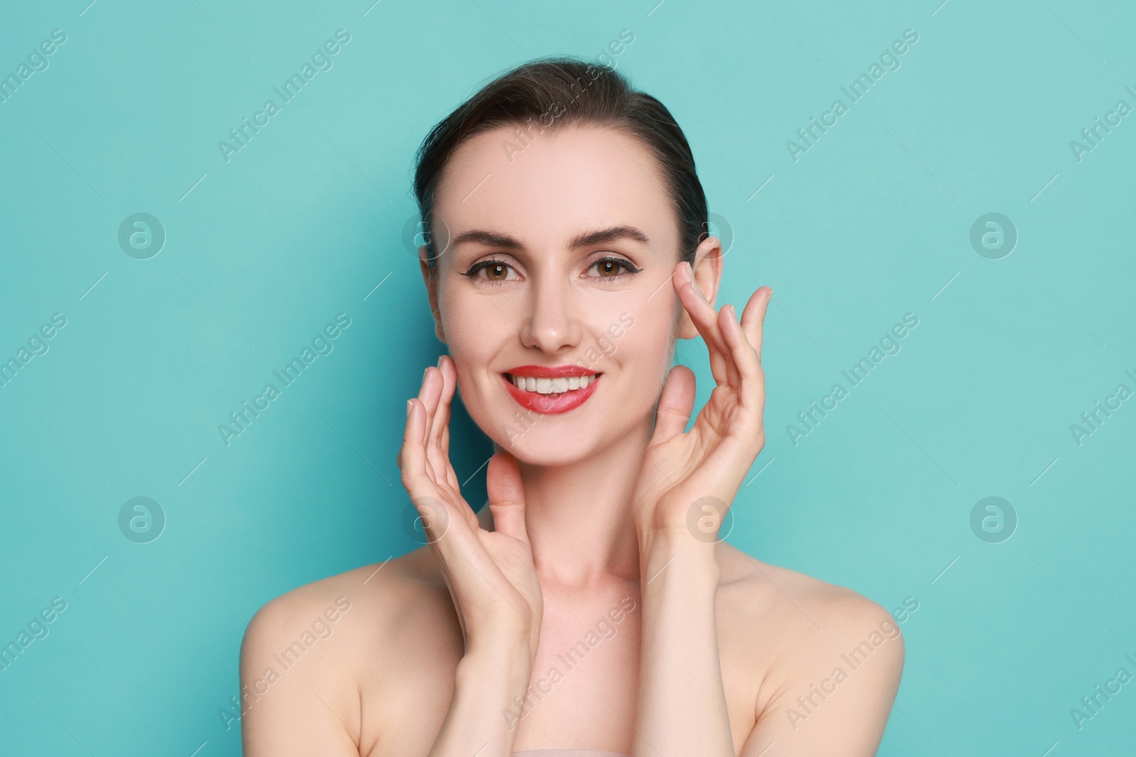 Photo of Smiling woman with perfect makeup on light blue background