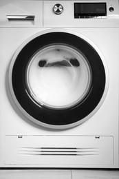 Photo of Washing machine with suds as background, closeup