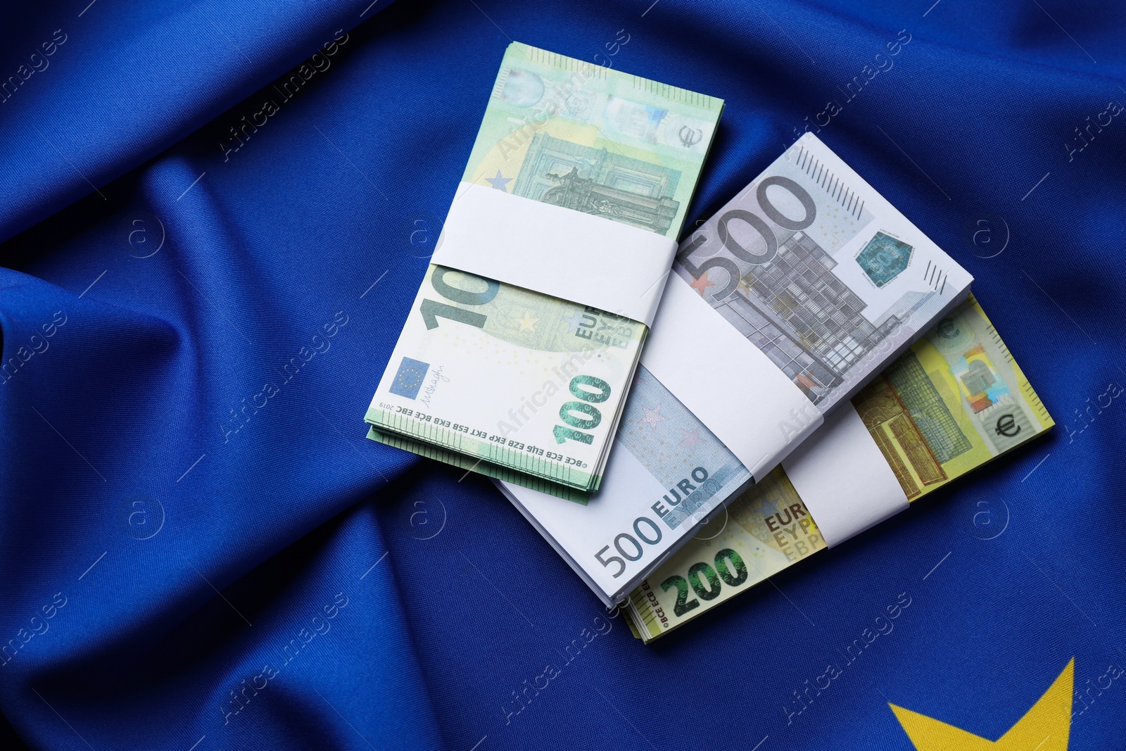 Photo of Euro banknotes on European Union flag, top view