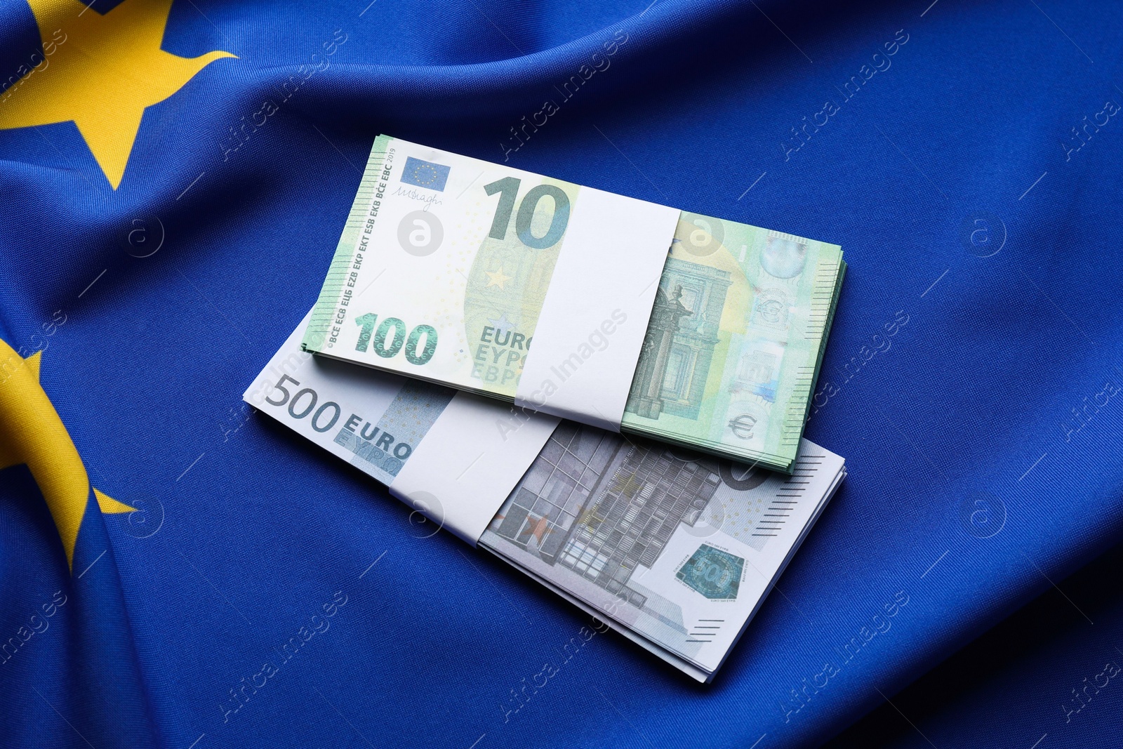 Photo of Euro banknotes on European Union flag, top view