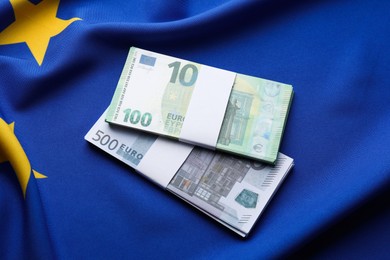 Photo of Euro banknotes on European Union flag, top view