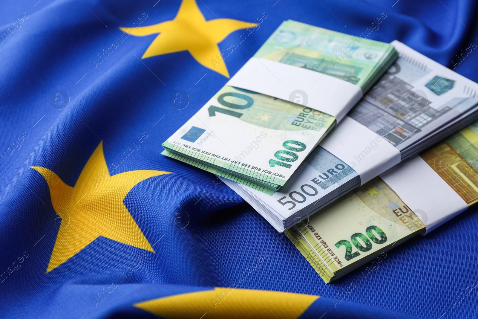 Photo of Euro banknotes on European Union flag, closeup