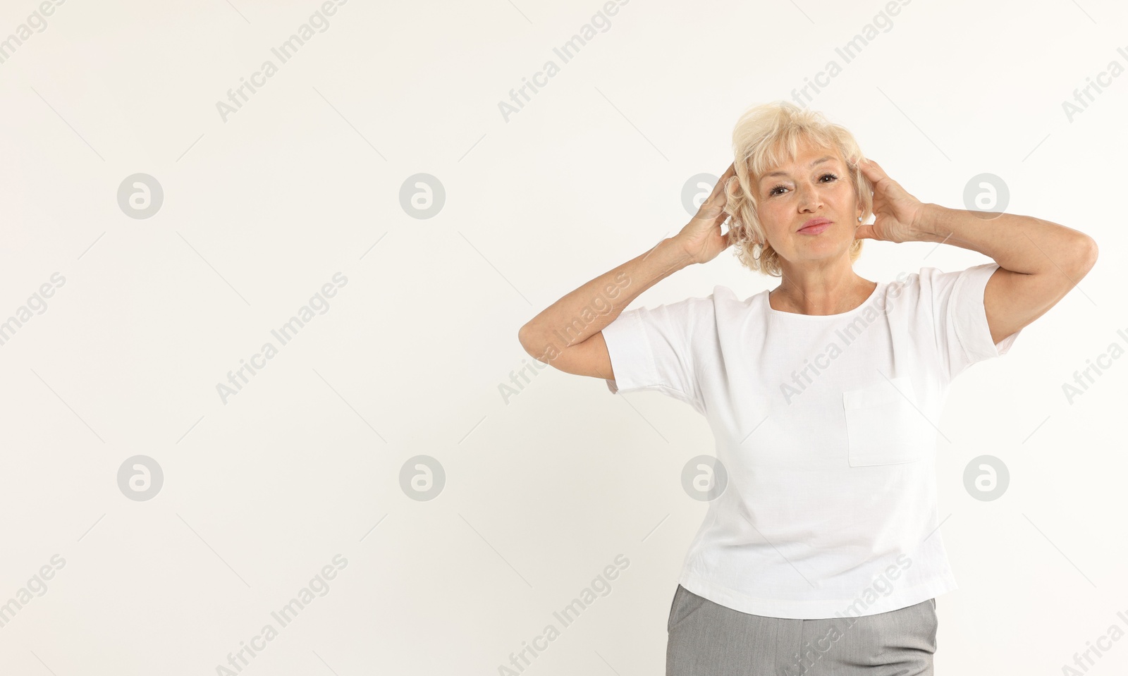 Photo of Portrait of beautiful senior woman on white background, space for text