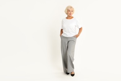 Photo of Full length portrait of beautiful senior woman on white background