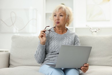 Photo of Beautiful senior woman using laptop at home