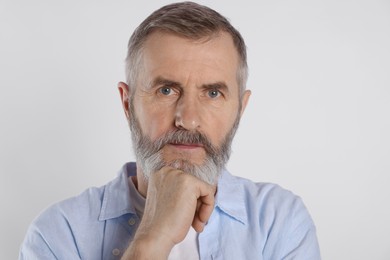 Photo of Portrait of senior man on white background