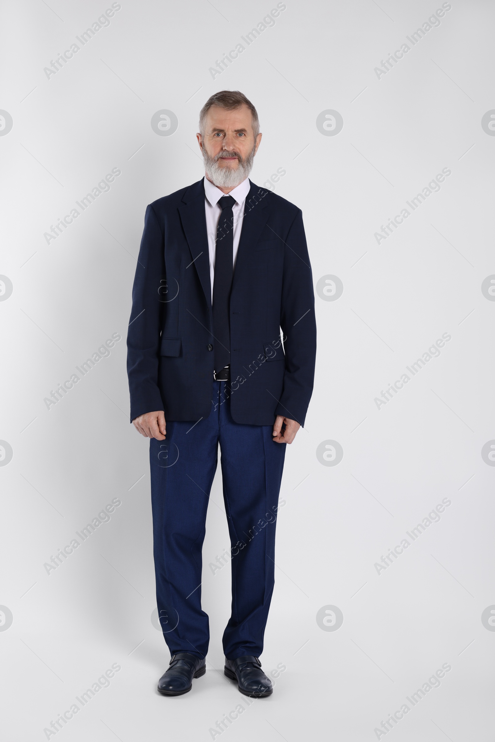 Photo of Portrait of senior man in suit on white background