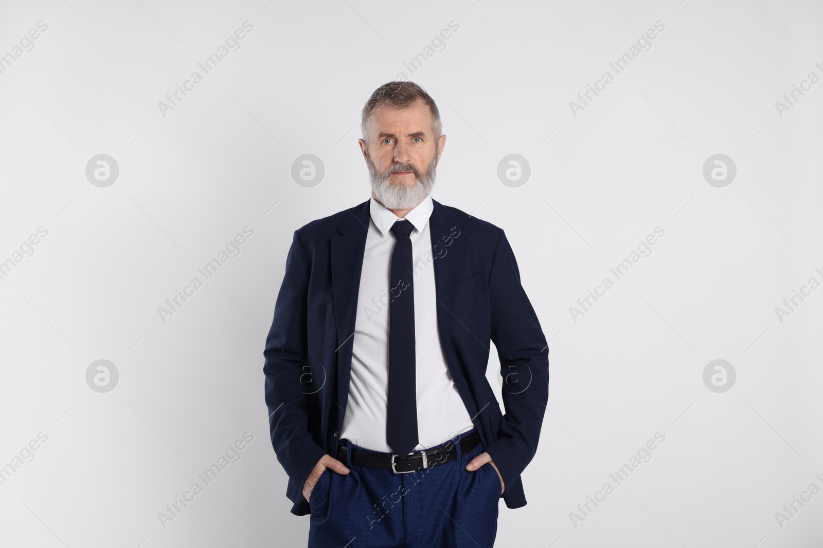 Photo of Portrait of senior man in suit on white background