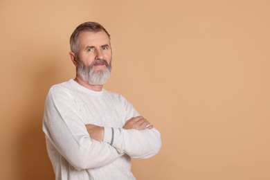 Photo of Portrait of senior man on beige background, space for text