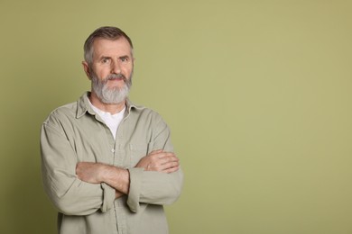 Photo of Portrait of senior man on green background, space for text